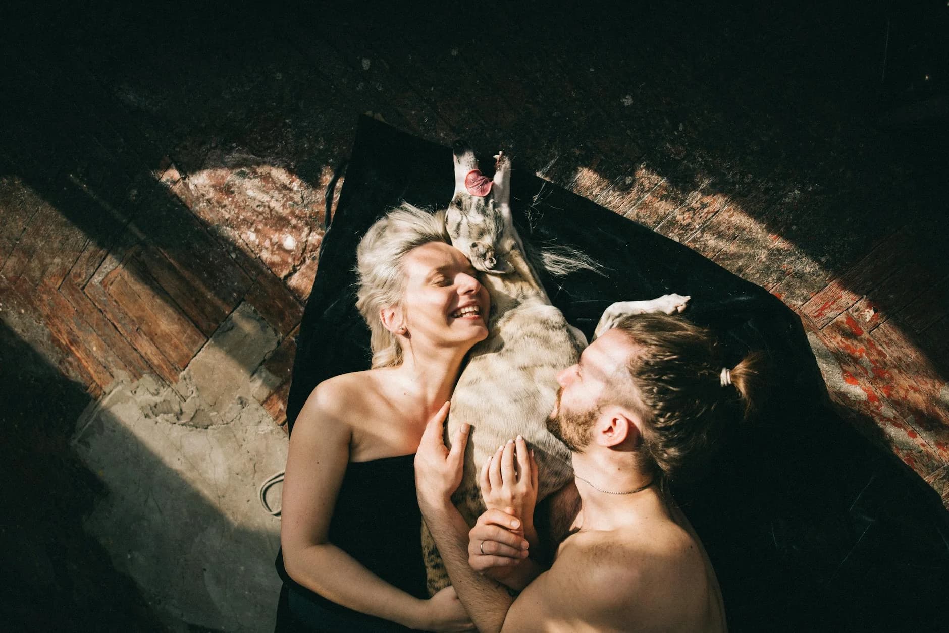 Happy couple on the floor with their dog